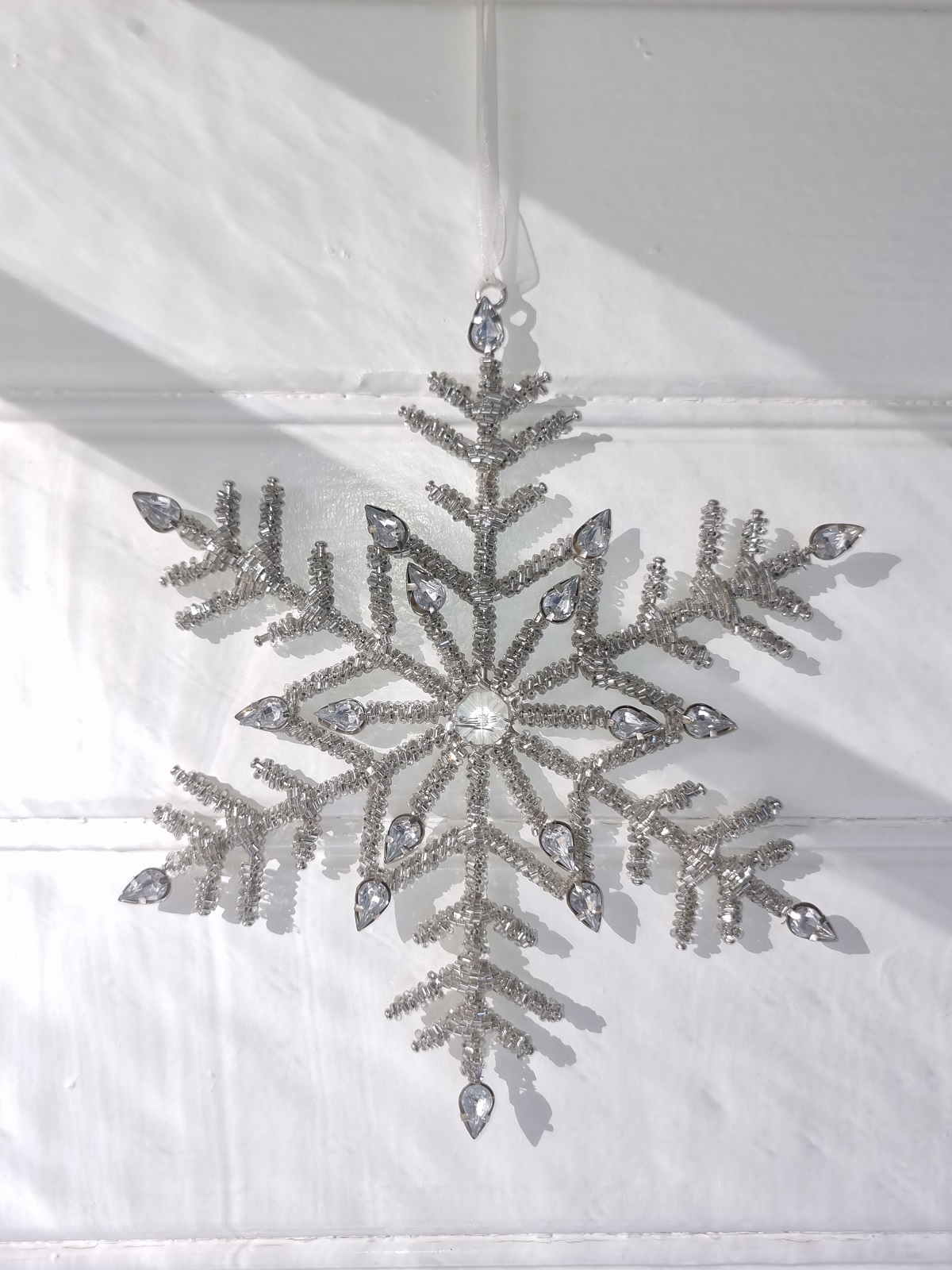 Snöstjärna i silver upphängning. Besök Blickfång.se
