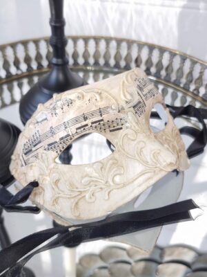 Venetiansk mask i beige med noter. Besök blickfång.se