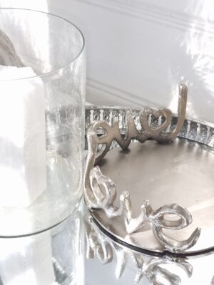 Ljuslykta silver på fat med texten love. Besök blickfång.se